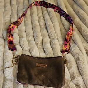 Elegant Brown Crossbody Bag with Vibrant Pink Strap